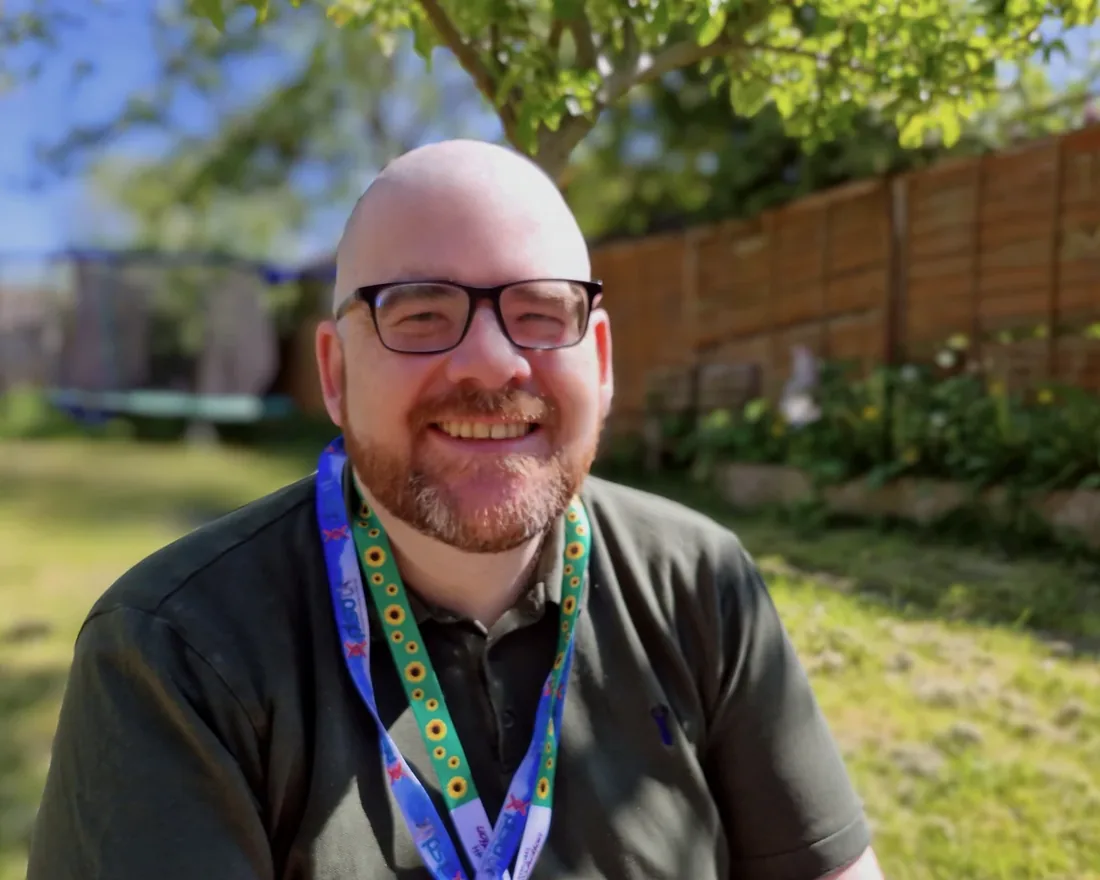 Sean Hegarty smiling outdoors in a garden