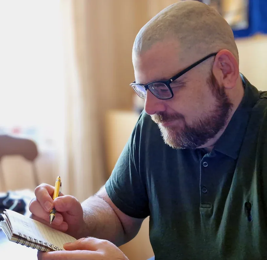 Sean Hegarty writing in a notebook